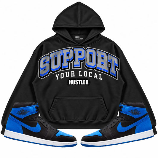 Rebranded Studios Support Your Local Hustler Air Jordan 1 Royal Reimagined Black hoodie — front with sneakers