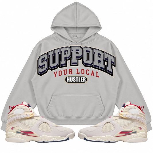 Rebranded Studios Support Your Local Hustler AIR JORDAN 8 X SOLEFLY “MI CASA ES SU CASA" Light Gray hoodie — front with sneakers