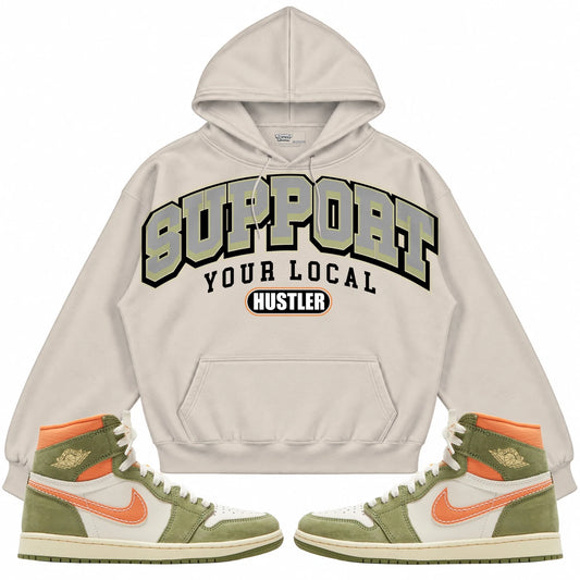 Rebranded Studios Support Your Local Hustler Air Jordan 1 High OG Craft “CELADON” cream hoodie — front with sneakers