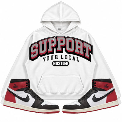 Rebranded Studios Support Your Local Hustler Air Jordan 1 High OG Black Toe Reimagined Collection White hoodie — front with sneakers
