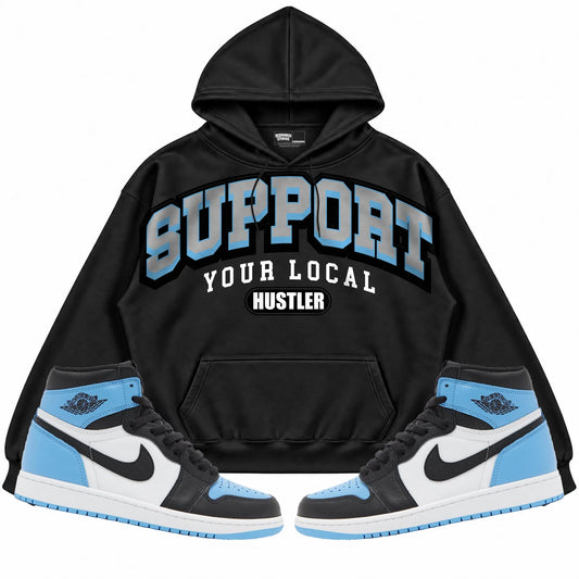 Rebranded Studios Support Your Local Hustler Air Jordan 1 High OG UNC Toe Black hoodie — front with sneakers
