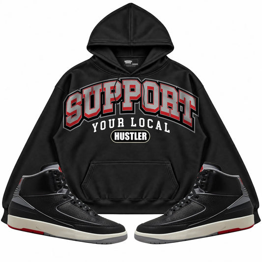Rebranded Studios Support Your Local Hustler Air Jordan 2 Black Cement Black hoodie — front with sneakers