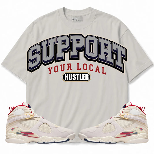 Rebranded Studios Support Your Local Hustler AIR JORDAN 8 X SOLEFLY “MI CASA ES SU CASA" Warm Off-White / Light Stone shirt — front with sneakers